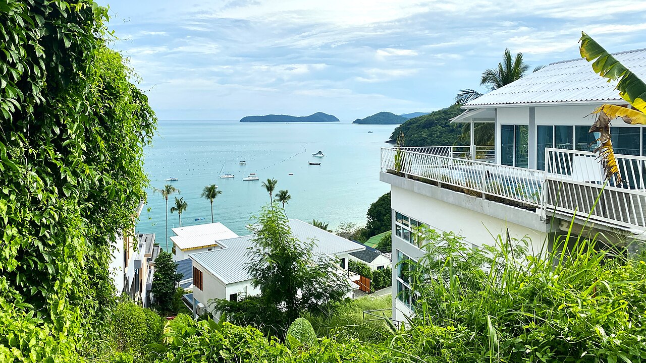 Ao Yon Bay seen between hillside greenery and buildings, with boats on the water